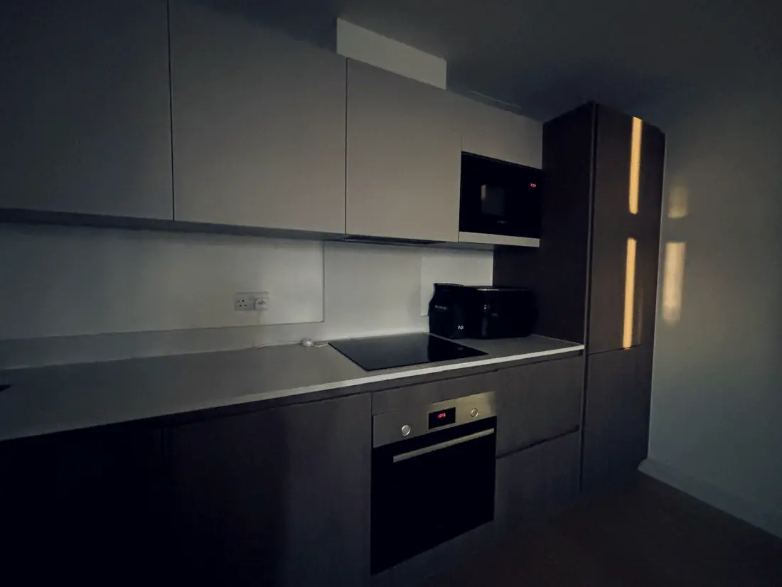 A fitted kitchen with the hob, oven and worktops left clear and wiped down.
